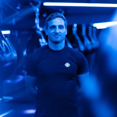 Professional male fitness instructor in a gym setting.